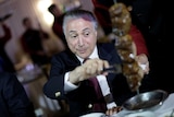 Brazil's President Michel Temer eats barbecue in a steak house.