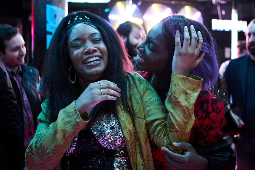 A scene from the TV series I May Destroy You with Michaela Coel and Weruche Opia dancing in a club