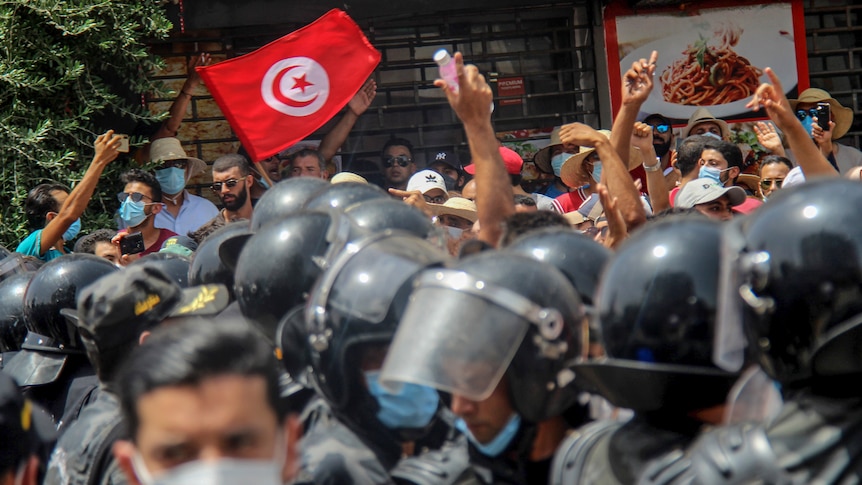Protesters face Tunisian police officers during a demonstration