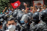 Protesters face Tunisian police officers during a demonstration