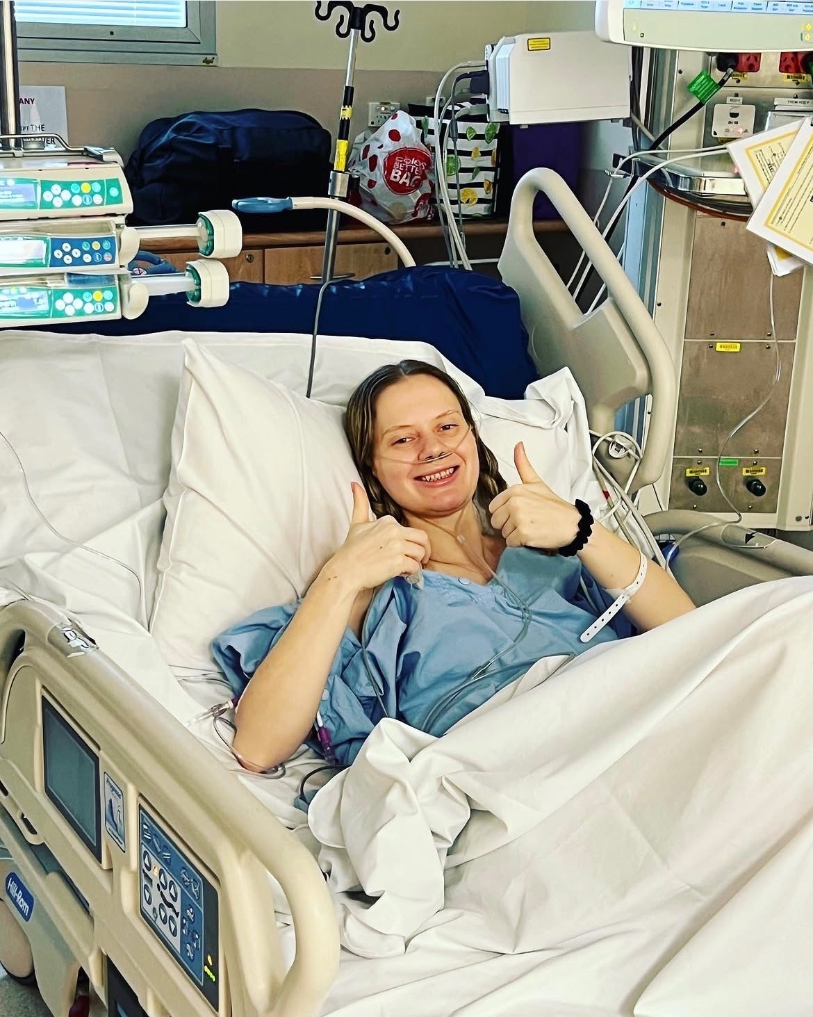 A young woman in a hospital bed. 