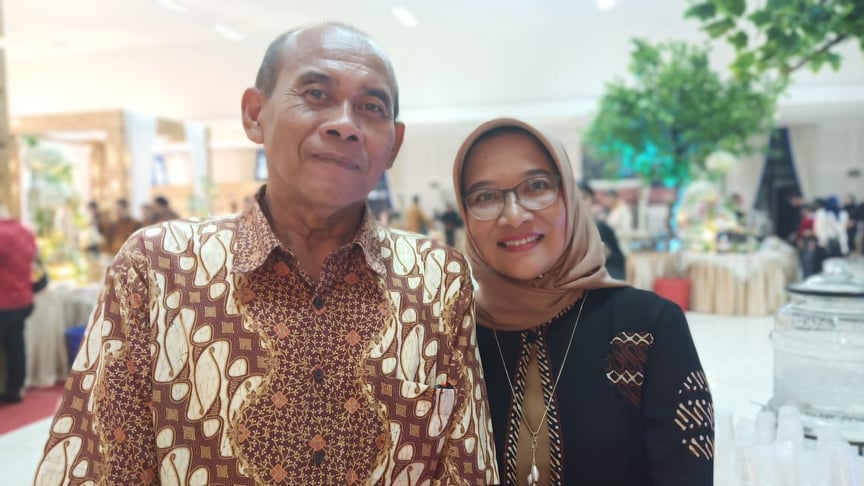 Dyah wearing headscarf with her husband wearing batik