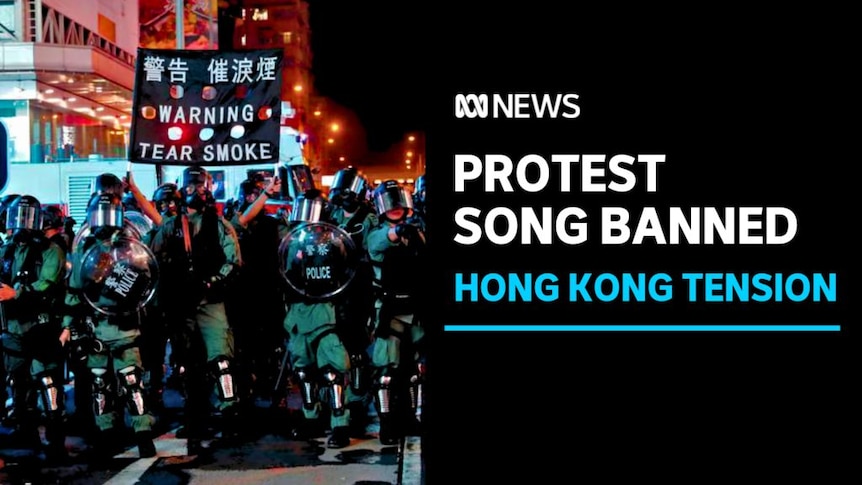 PROTEST SONG BANNED, HONG KONG TENSION: A group of Hong Kong police, one holds a sign reading "WARNING TEAR SMOKE" 