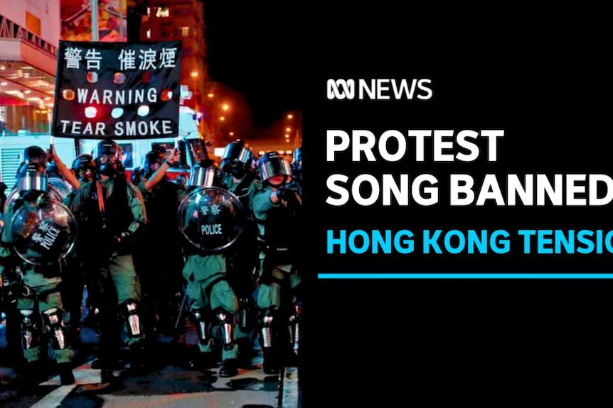 PROTEST SONG BANNED, HONG KONG TENSION: A group of Hong Kong protesters, one holds a sign reading "WARNING TEAR SMOKE" 