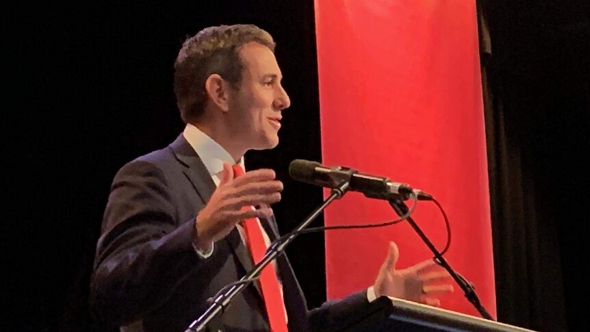 Shadow Federal Treasurer Jim Chalmers speaking at podium, gesticulating.