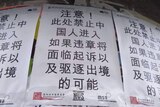 Racist posters in a Chinese dialect targeting foreign students.