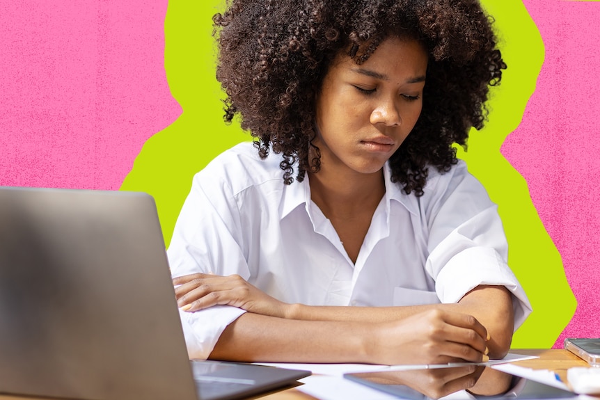 A woman in a white business shirt sits at a desk in front of a laptop and frowns. She's surrounded by a pink graphic design 