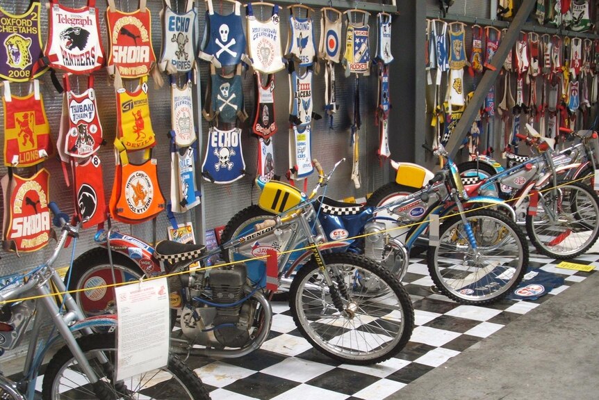 A collection of speedway motorbikes and jersey's