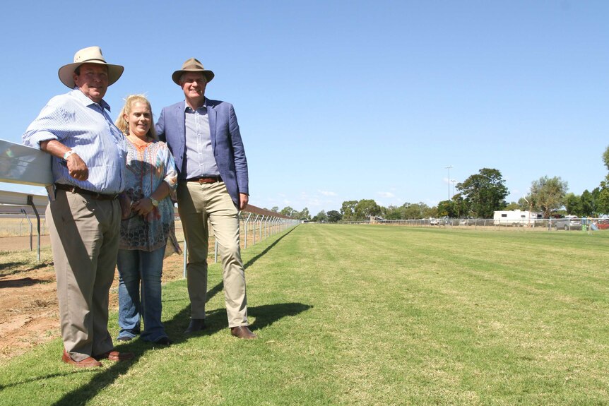 Minister for Racing Stirling Hinchcliffe, Barcaldine Mayor Rob Chandler and local Toni Austin stand on Barcaldine's turf track