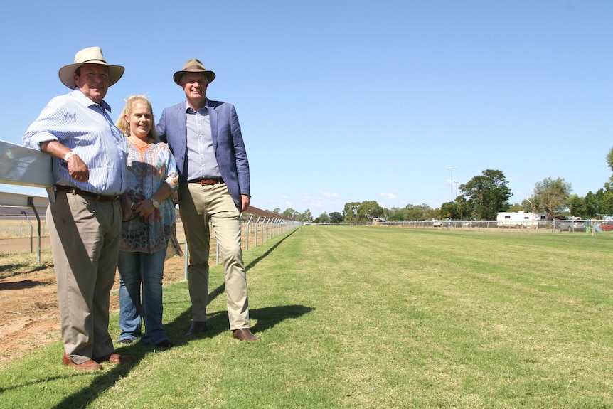 Minister for Racing Stirling Hinchcliffe, Barcaldine Mayor Rob Chandler and local Toni Austin stand on Barcaldine's turf track