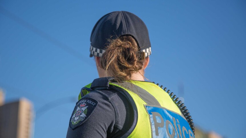 Female Victoria Police officer with her back to camera.