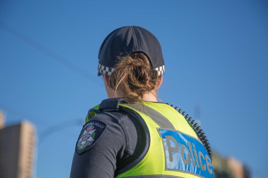Female Victoria Police officer with her back to camera.