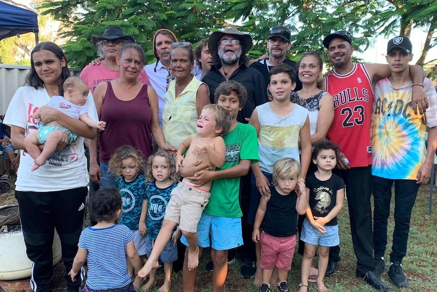 A large family stand together for a group photo.