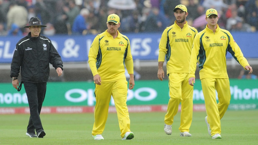 Steve Smith leads Australia off the park as rain falls during the Champions Trophy clash with England