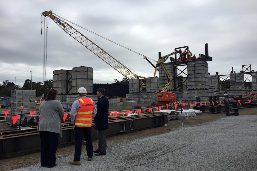 People inspect the construction site where two 180-metre-long bridges will be built.