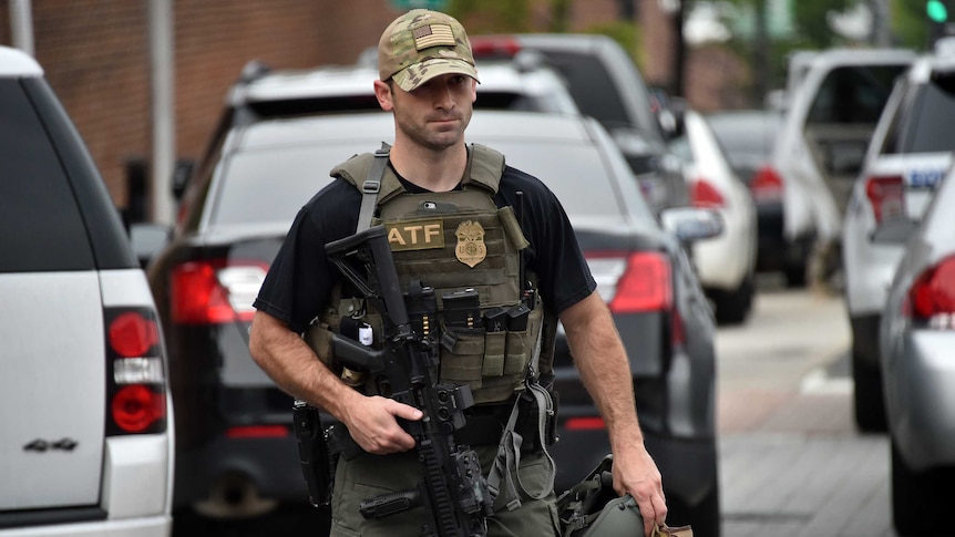 An ATF officer arrives near the scene of an unconfirmed shooting at the Navy Yard in Washington, DC