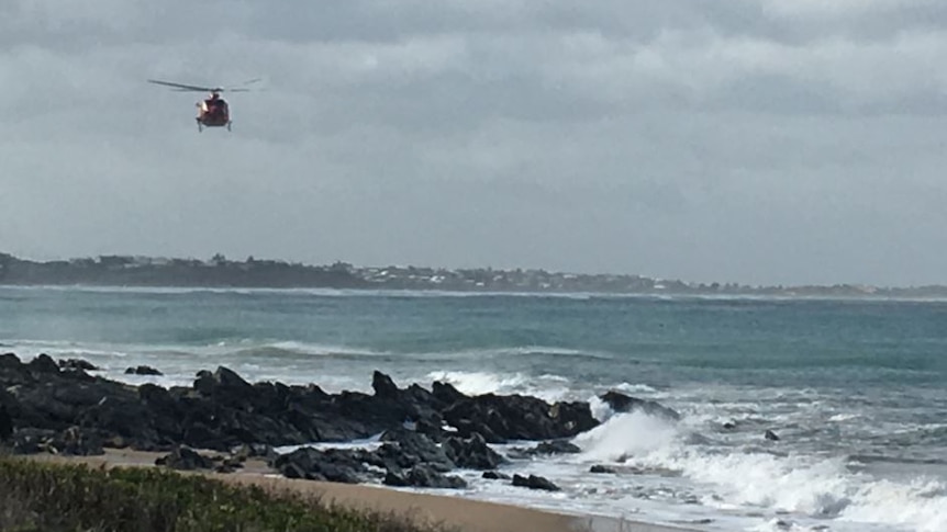 A helicopter flying above the ocean at Bashams Beach