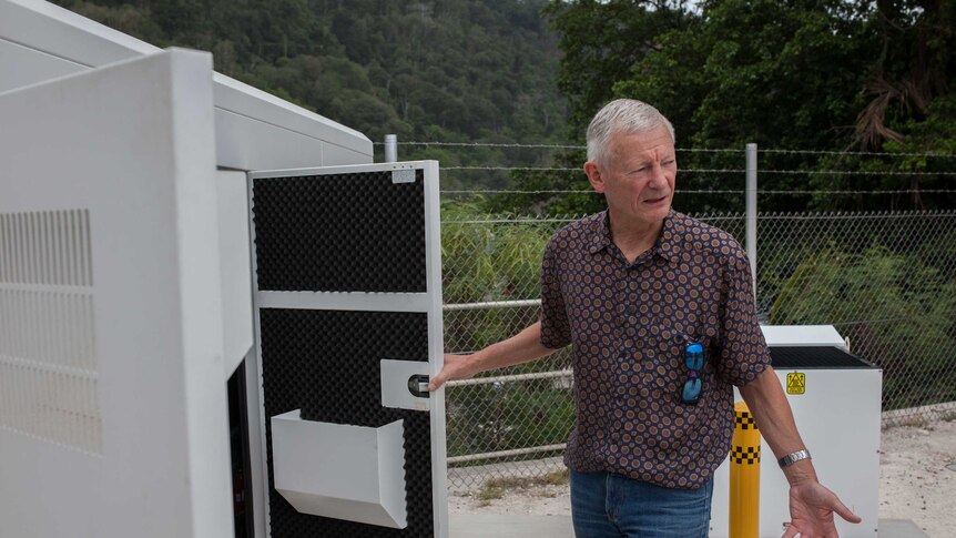 A Vocus Communications employee inspects a diesel generator on Christmas Island.