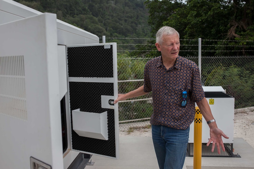 A Vocus Communications employee inspects a diesel generator on Christmas Island.