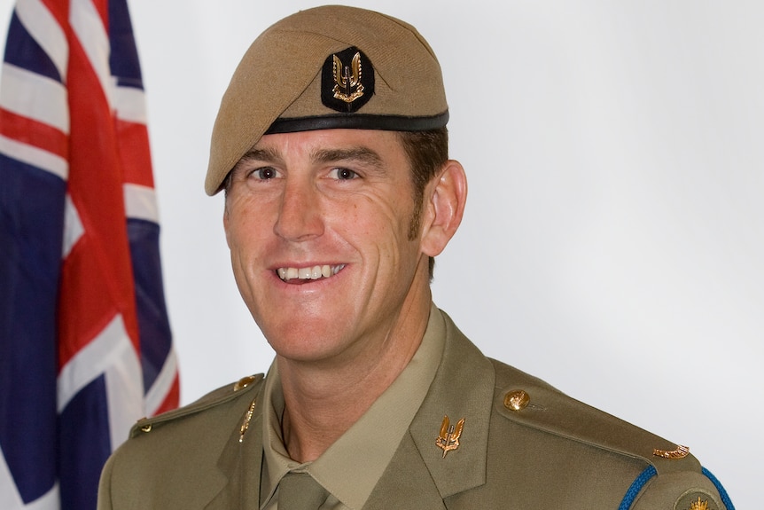 an army soldier wearing his uniform and a beret