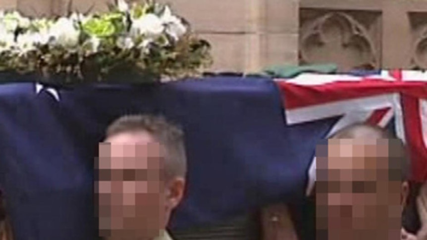 Pallbearers carry Sergeant Brett Wood's casket
