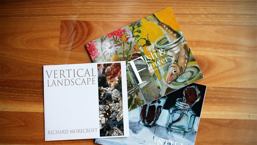 Art books by Richard Morecroft and his partner Alison Mackay on a wooden floor.