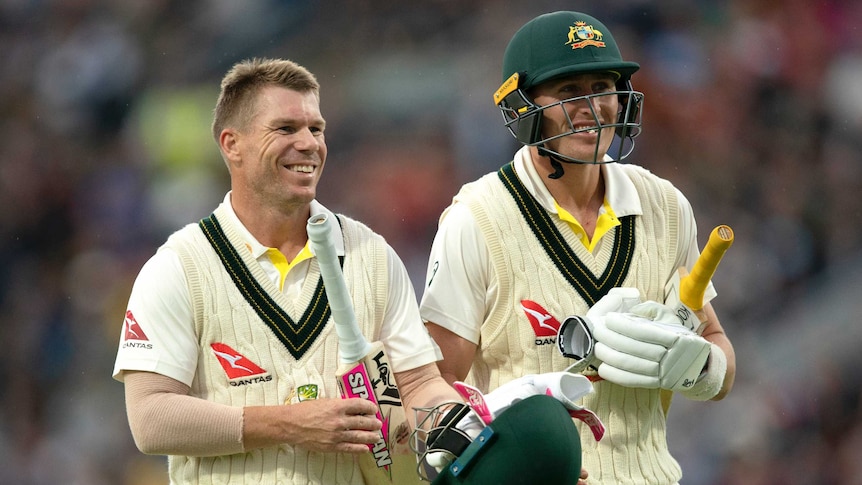 Australia batsmen David Warner and Marnus Labuschagne smile as they walk off the field during the third Ashes Test at Headingley