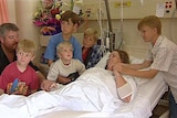 Becky Cooke in hospital with her husband and five children