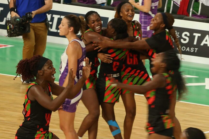 Malawi players celebrate on the netball court.
