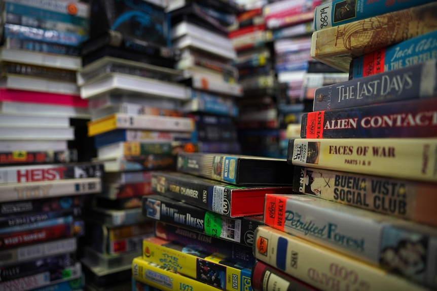 A stack of video tapes piled up in a warehouse