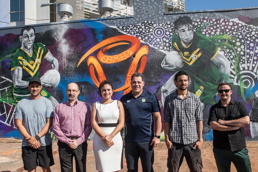 NT Minister for Tourism standing with Mal Meninga and Local artists