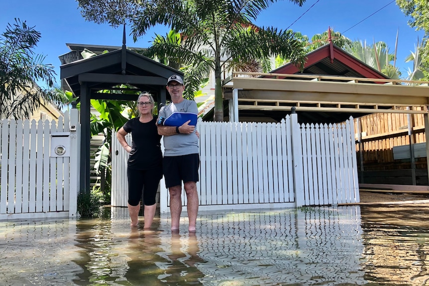 Stephen and Karen stand outside their home.