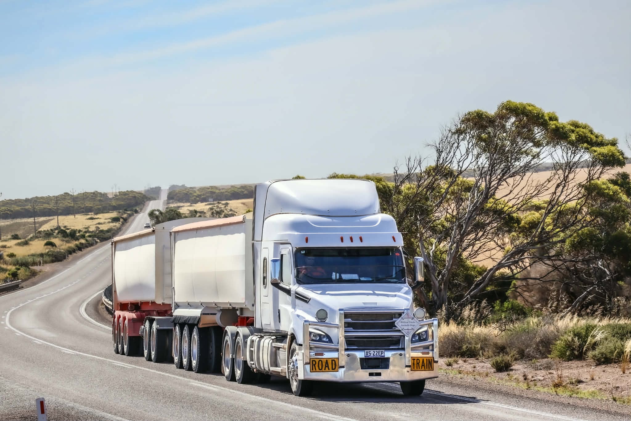 A truck travels on an open road.