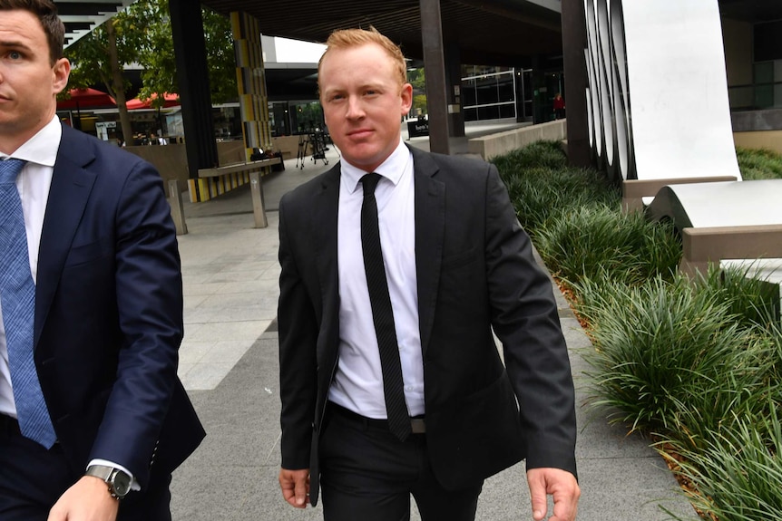 Former Harness racing driver Barton Cockburn (right) leaving the Magistrates Court in Brisbane.