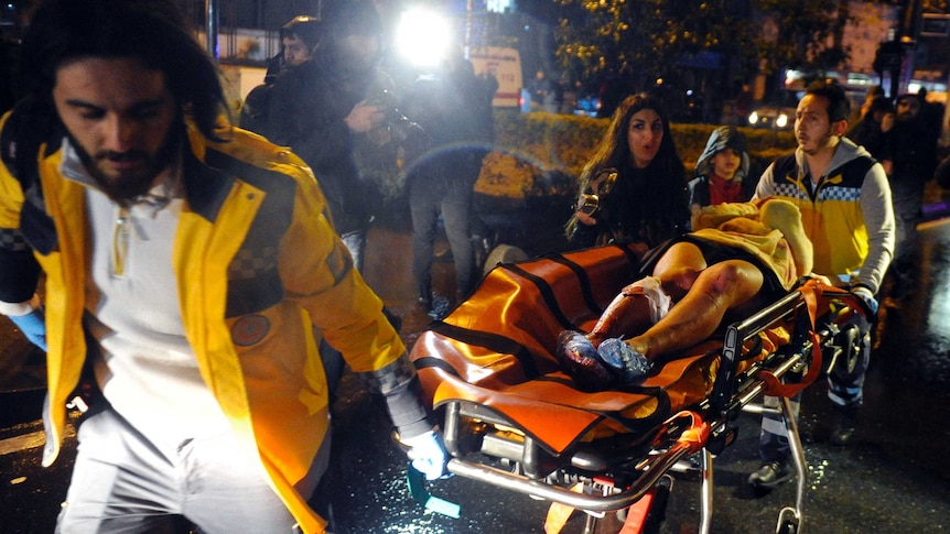 Medics pushed an injured person on an ambulance trolley at the scene of the Istanbul shooting.
