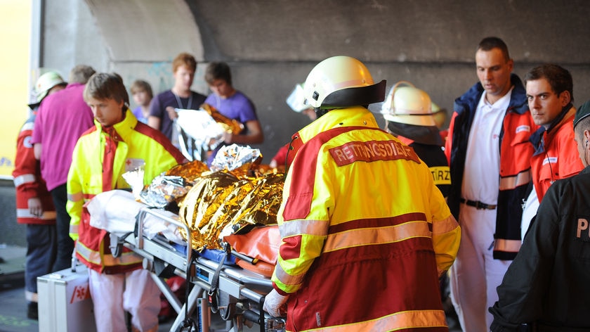 Tragedy hits: emergency services staff work after panic broke out in a tunnel at the Love Parade