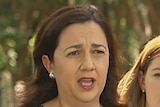 Queensland Premier Annastacia Palaszczuk speaking to media, with Minister for Women Shannon Fentiman behind her