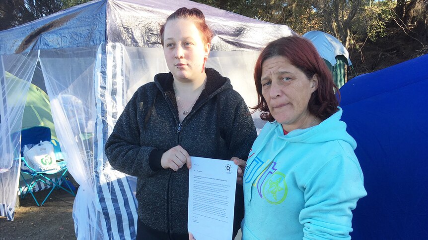Homeless people holding an eviction letter from Glenorchy City Council. Tamika Clark and Bonnie Hyland