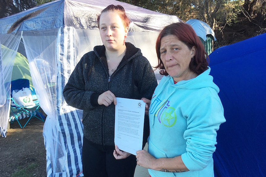 Homeless people holding an eviction letter from Glenorchy City Council. Tamika Clark and Bonnie Hyland