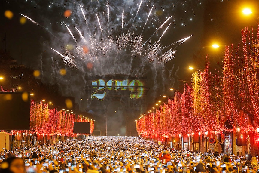 Fireworks illuminate the sky over the Arc de Triomphe