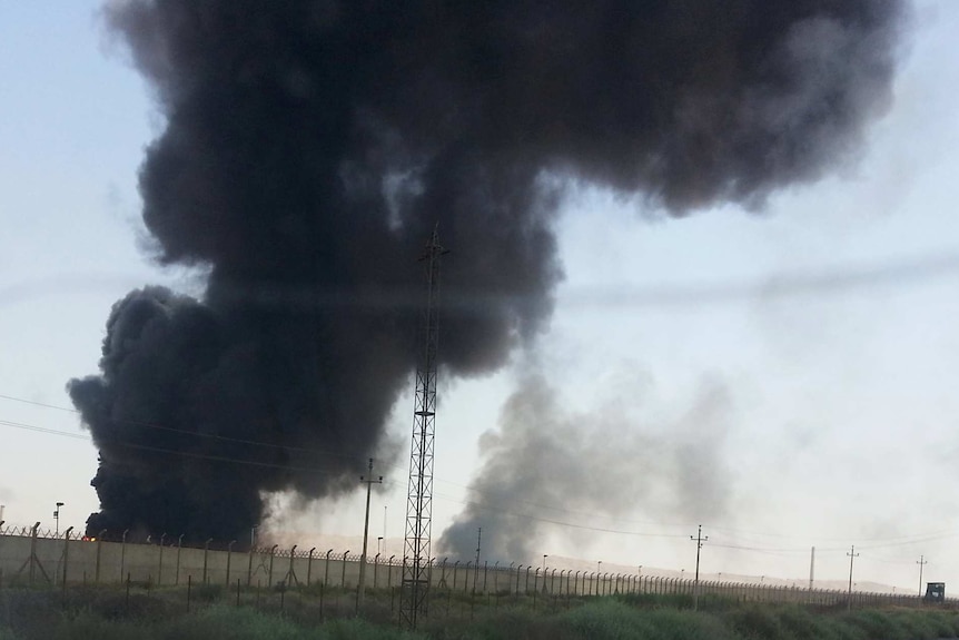 Smoke rises from a oil refinery in Baiji, north of Baghdad.