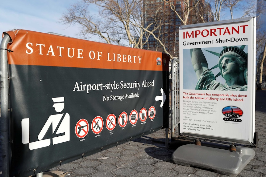 A sign announcing the closure of the Statue of Liberty, due to the US government shutdown