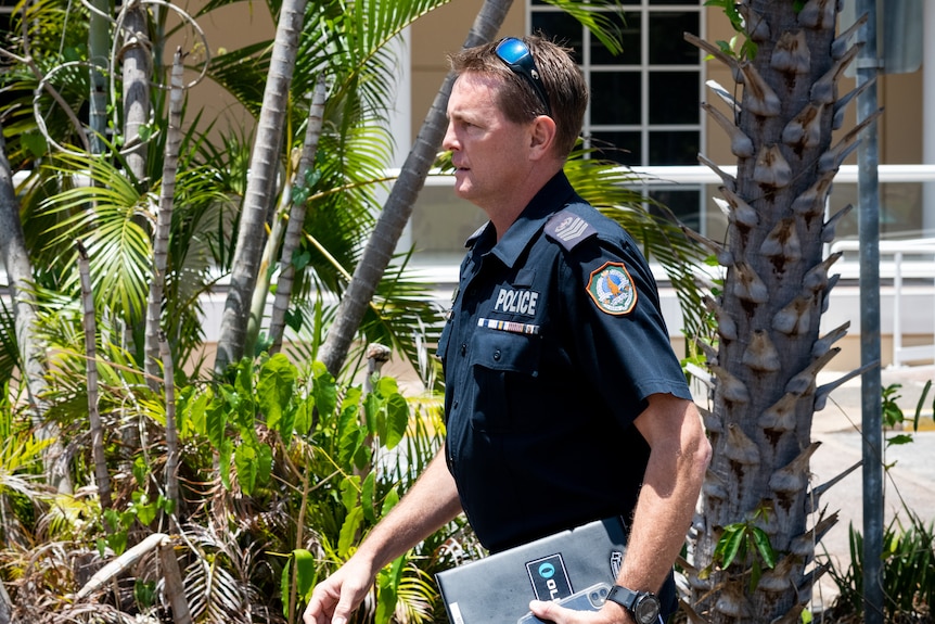 a male police officer exiting darwin court
