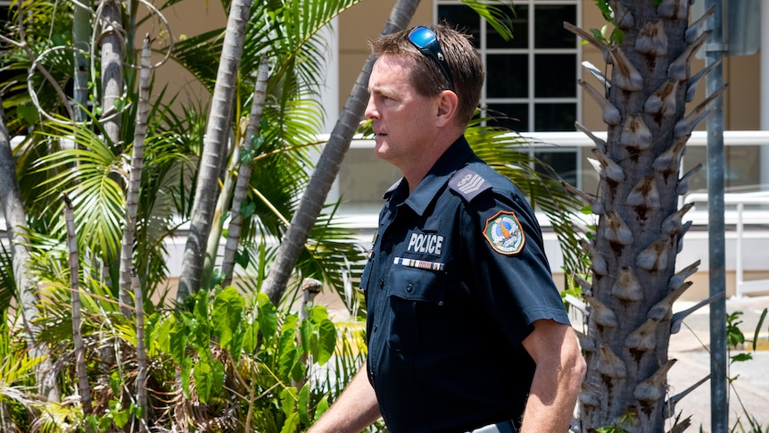 a male police officer exiting darwin court