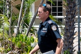 a male police officer exiting darwin court