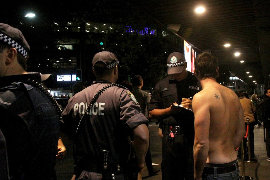 Police speak to a young man in Kings Cross.