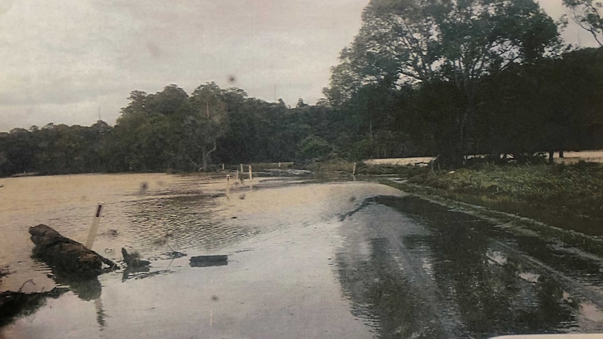 A picture tendered as evidence of Dulguigan Road the day before the tragedy, showing flood water across the road