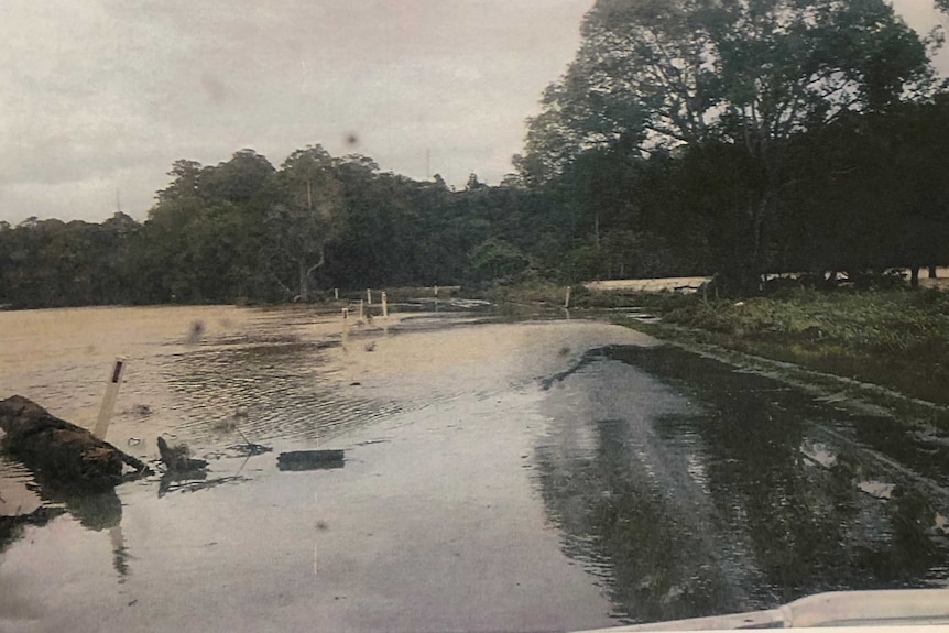 A picture tendered as evidence of Dulguigan Road the day before the tragedy, showing flood water across the road.