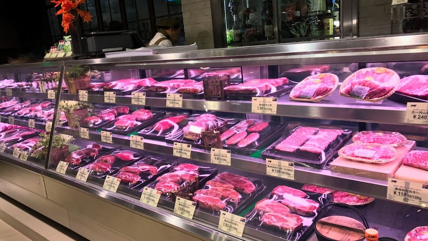 Meat in a butcher's window with Chinese labels