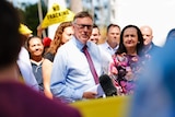 Territory Alliance leader Terry Mills speaks to the media in front of a crowd, some holding "No Fracking" signs